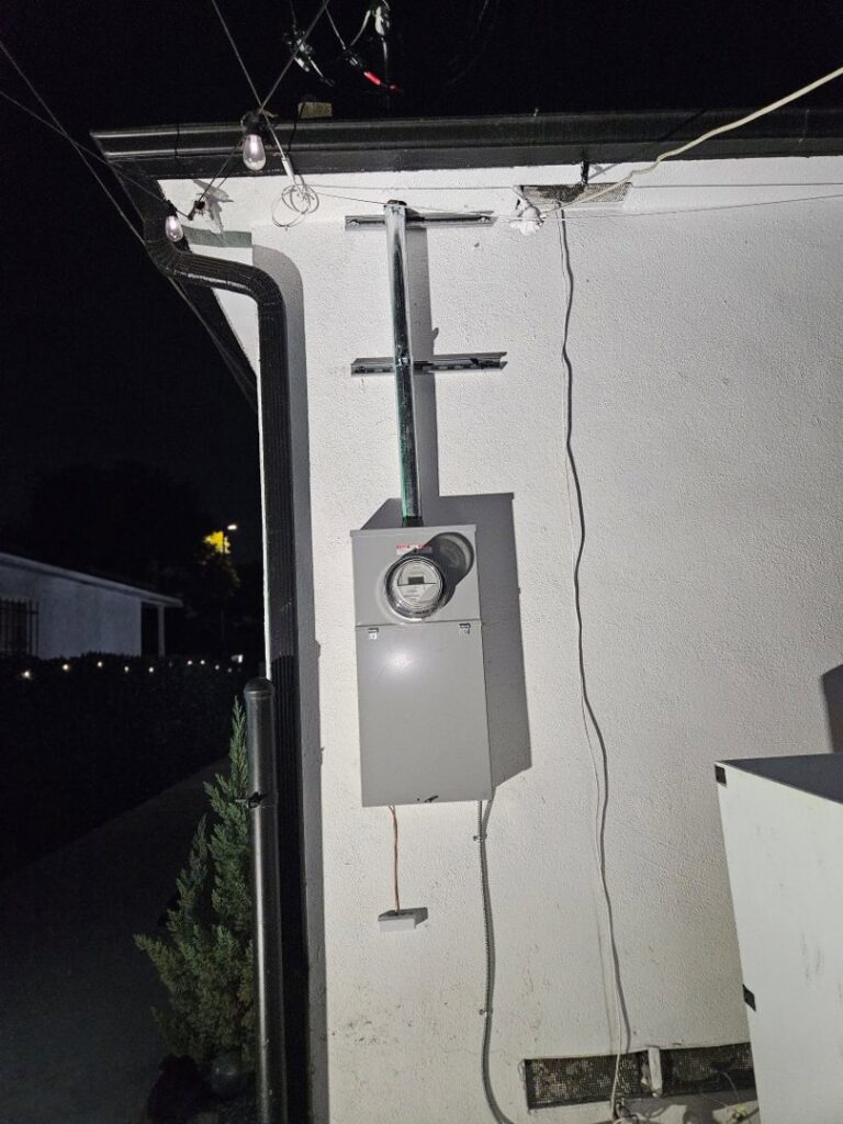 An exterior electrical meter and conduit installation on a residential building by Muse Electricians in Los Angeles, CA.