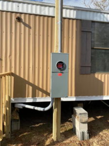 An exterior electrical meter box and conduit installation on a pole by Pierce Electric, LLC in Fayetteville, NC