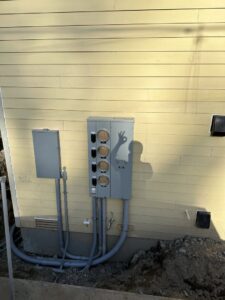 Exterior electrical meter base and conduit installation on a building by Watts Up Electric in Crystal Lake, IL.