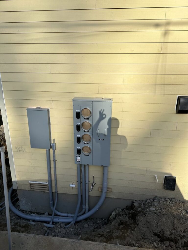 Exterior electrical meter base and conduit installation on a building by Watts Up Electric in Crystal Lake, IL.