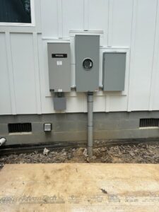 Exterior electrical meter and panel installation, including Generac components, by Prime Time Electric in Rock Hill, SC.