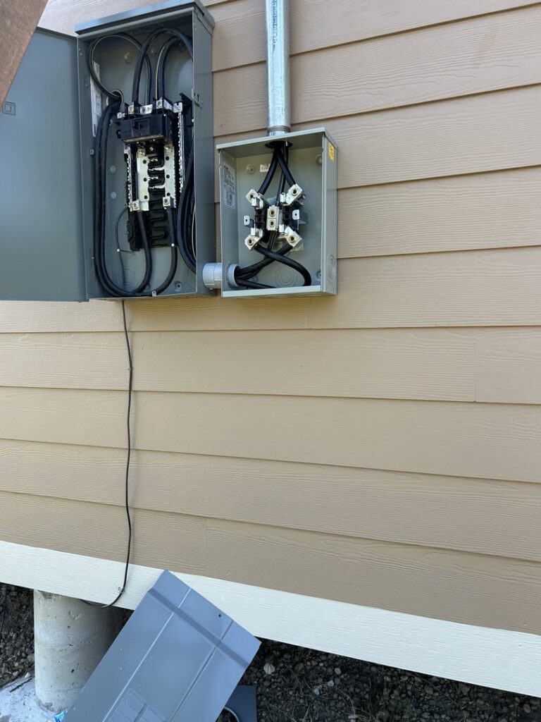 Exterior electrical meter and service panel installation on the side of a building by Ultralight Electric in Houston, TX.