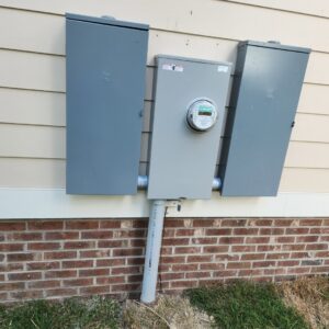 Exterior electrical meter and service boxes installed on a building by Tim Lambert Electric in Fayetteville, NC.