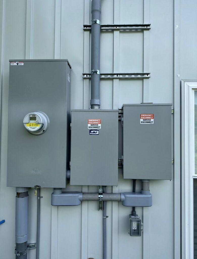 A professionally installed exterior electrical meter and service disconnect boxes by Grounded Electric LLC in Smithfield, VA.