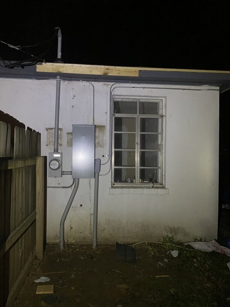 Exterior view of an electrical meter and service panel on a building, maintained by Ross Electric Company in Arlington, TN.