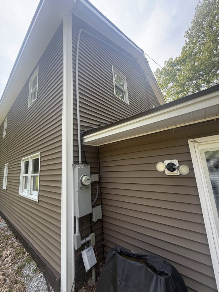 An exterior electrical meter and conduit on the side of a house, serviced by Rockys electric in La Junta, CO.