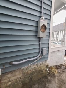 Exterior electrical meter and conduit installed on the side of a house by Rudis Electrical LLC in Scranton, PA.