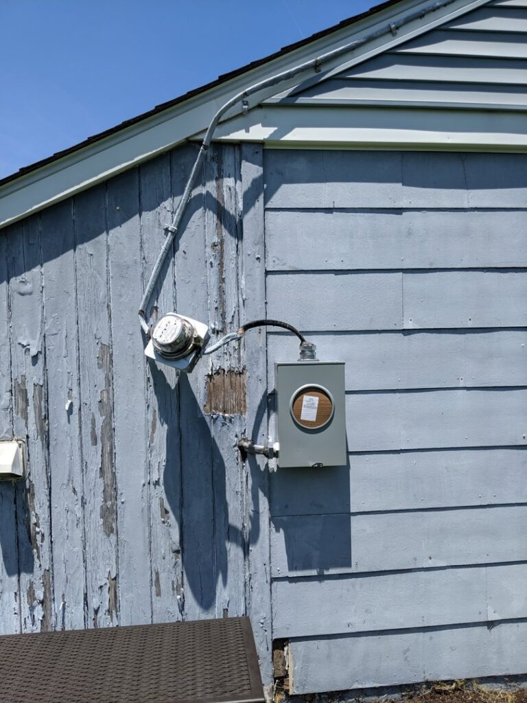 Exterior electrical meter and service entrance conduit on a residential building by ZAP Electric LLC in Greeley, CO.