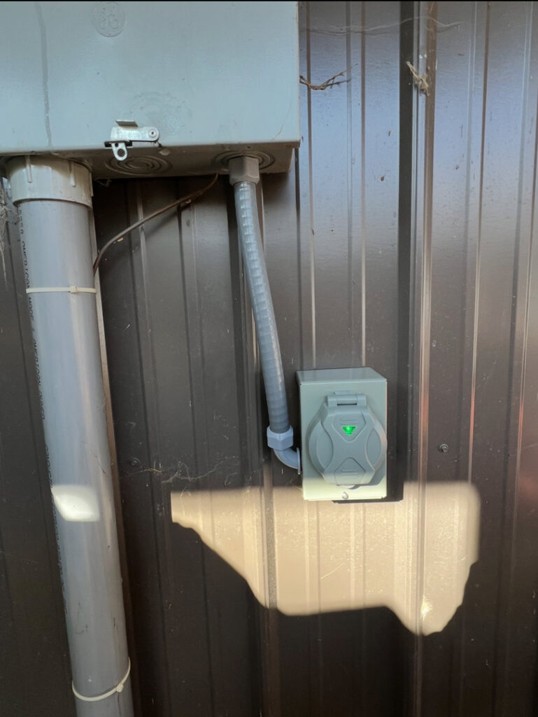 An exterior electrical outlet installation on a metal building by Raschke & Sons Electric in Chattanooga, TN