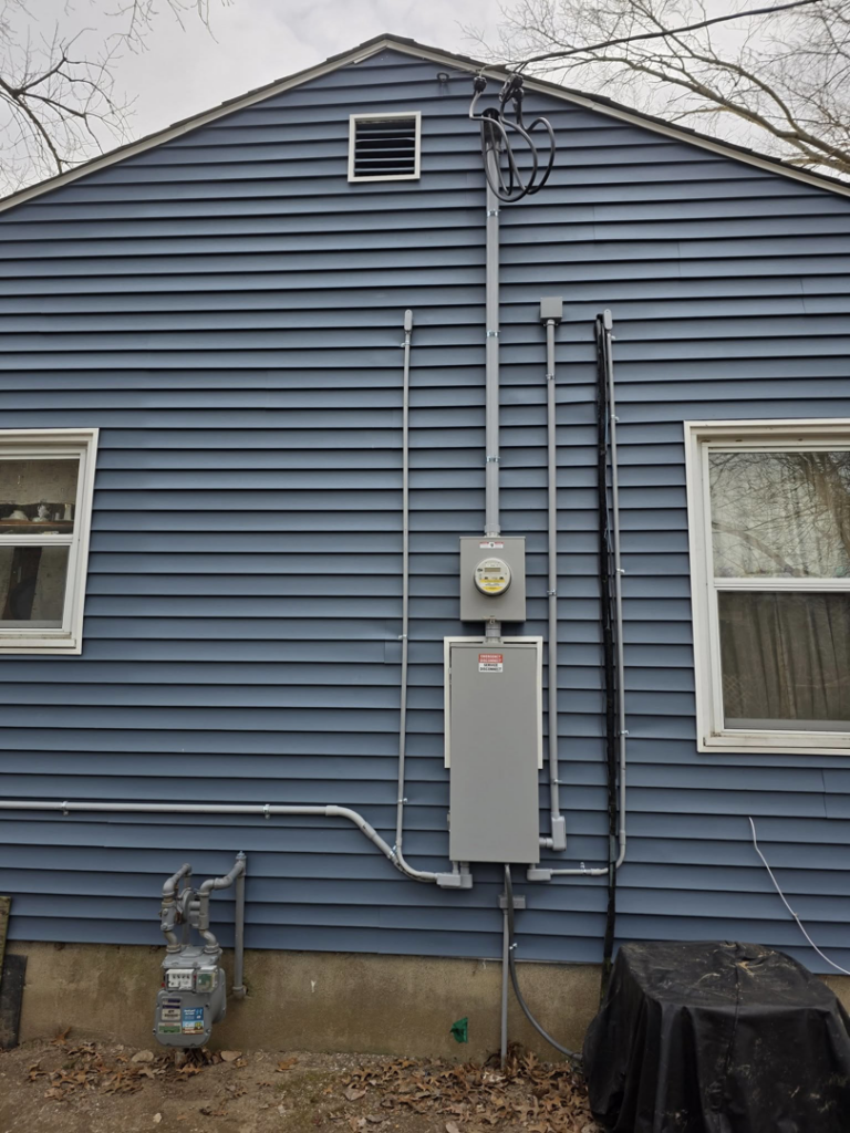 Exterior electrical panel and meter installation on a home by 1st Class Electric in Cranford, NJ.