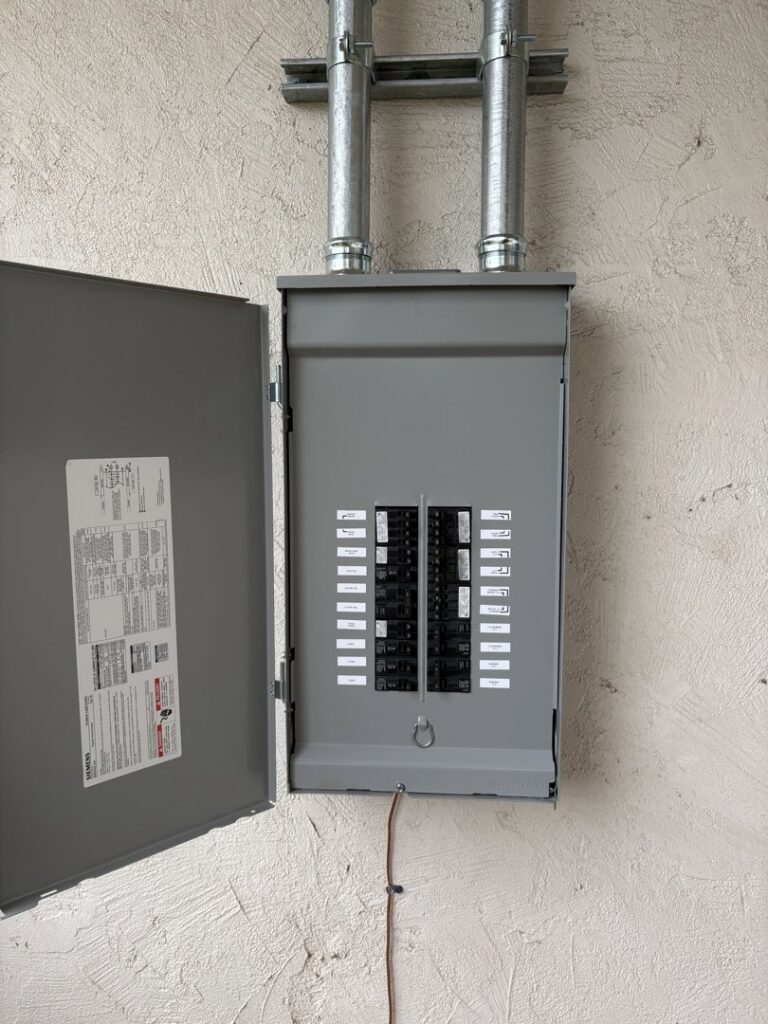 An exterior electrical panel with conduit installed by Big Red Electric Company in San Antonio, TX.