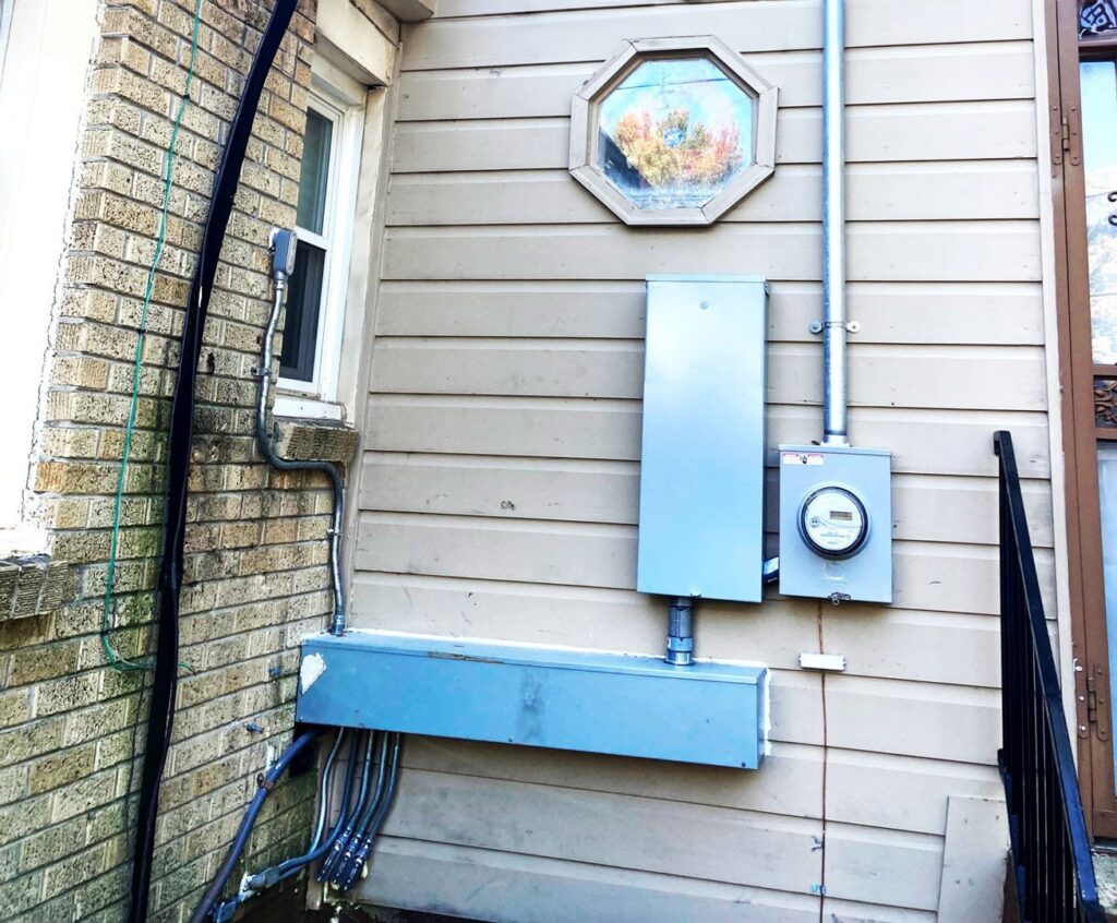 Exterior electrical service panel and meter installed on the side of a building by Ace Electric Inc. in Valdosta, GA.
