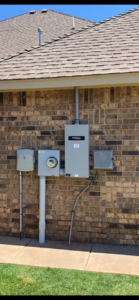 An exterior electrical panel and meter installation on a brick wall by Burton Controls in Oklahoma City, OK.
