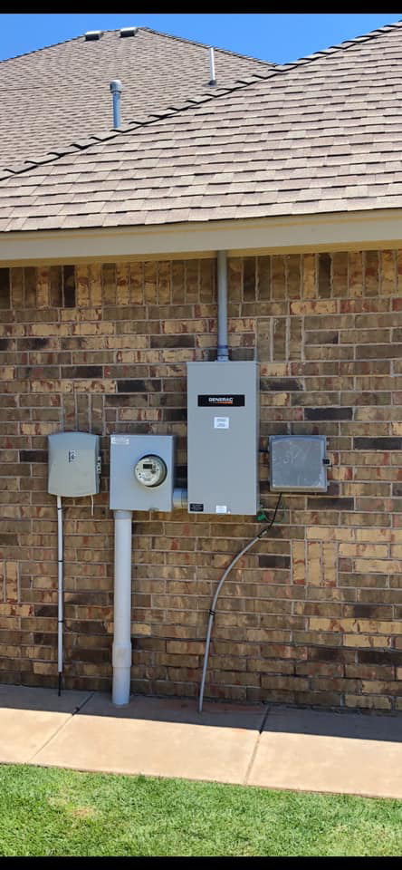 An exterior electrical panel and meter installation on a brick wall by Burton Controls in Oklahoma City, OK.