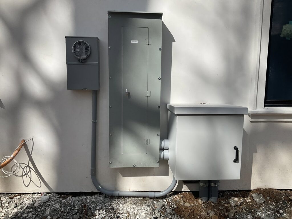 Exterior electrical panel and meter base installation on a building by E-Systems Electrical Inc. in Cumming, GA.