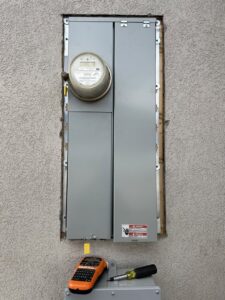 An exterior electrical panel and meter installation with tools nearby by Jolt Electric in Salem, MA