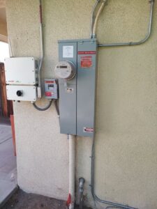 An exterior electrical panel and solar inverter installation by Electrical Power Source in Fresno, CA.
