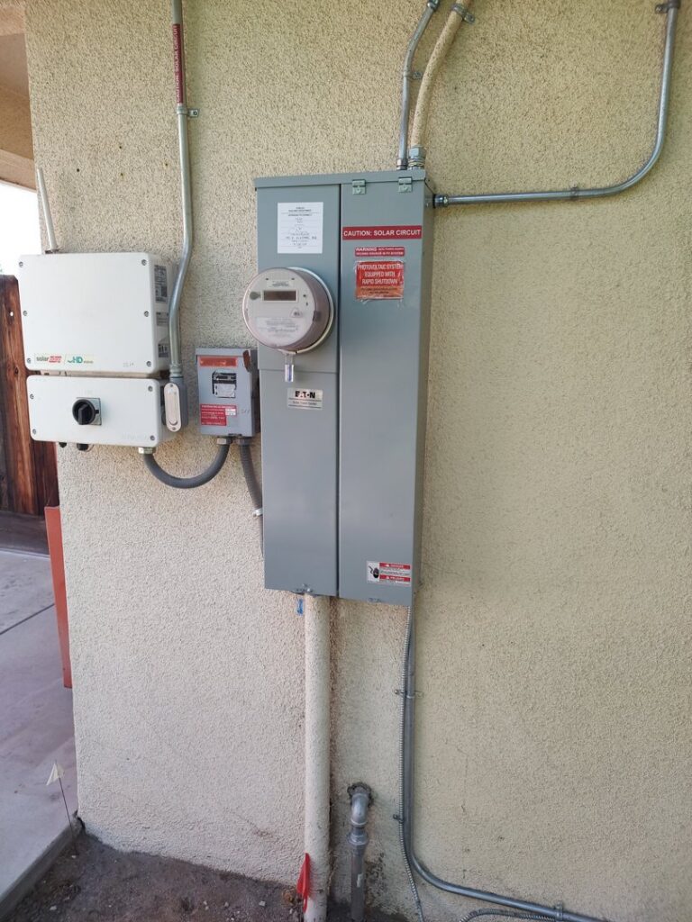 An exterior electrical panel and solar inverter installation by Electrical Power Source in Fresno, CA.
