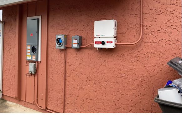 Exterior electrical panel and solar inverter installation by Madison Electrician Now in Madison, AL.