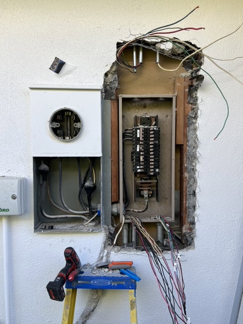 An exterior electrical panel being upgraded or repaired by Gilmore Electrical in Saint Louis, MO