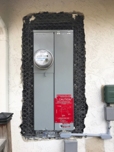 An exterior electrical service panel undergoing an upgrade or installation by Premo Electric in Spring Valley, CA