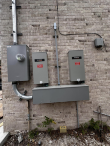 Exterior electrical panels and Generac transfer switches installed by A&f electric service in Houston, TX