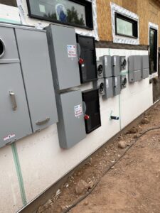 Exterior electrical panels and meter bases installed on a new construction building by EV Electric LLC in Mesa, AZ