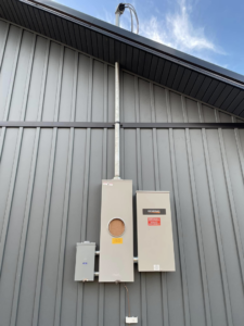 Exterior electrical service entrance and Generac generator transfer switch installed by Leggett Electric LLC in Jackson, TN.