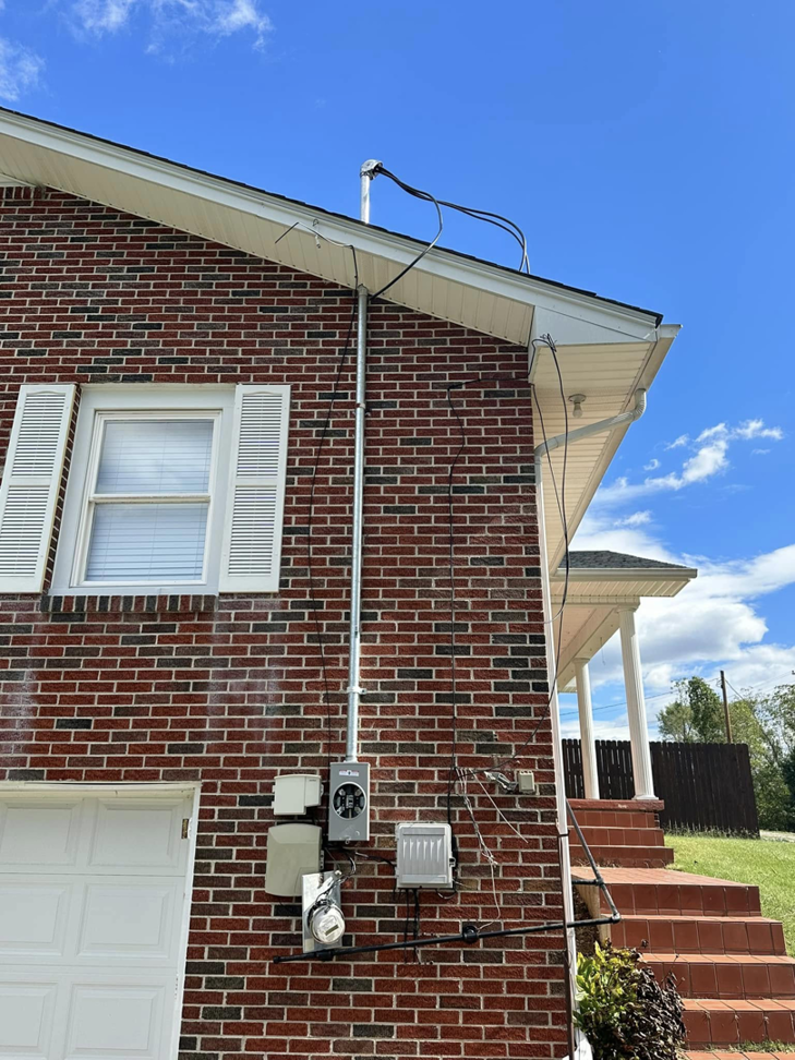 Exterior electrical service mast and meter installation on a brick home by KW Electric in Johnson City, TN