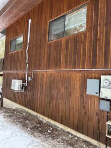 Exterior electrical service installation with conduit, meters, and panels on a house by Sunrise Electric LLC in Kalispell, MT.