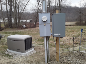 An exterior electrical service mast and meter on a brick house, installed by Bluegrass Power & Electric in Lexington, KY.