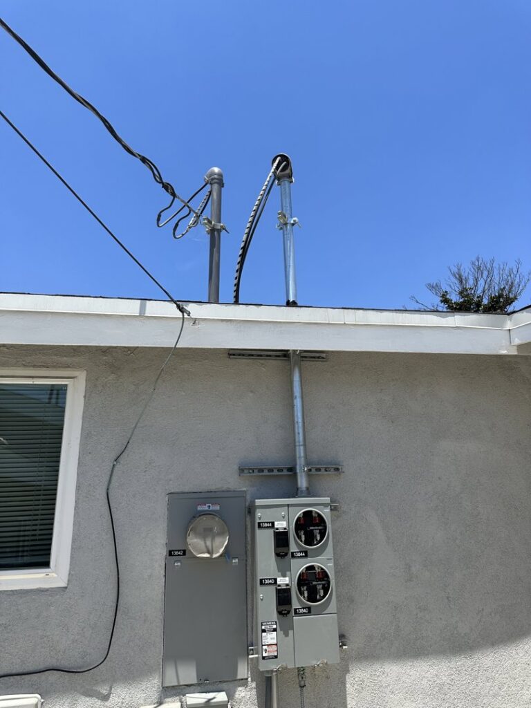 Exterior electrical service mast and multiple meter installation by Positive Electricians in Van Nuys, CA.