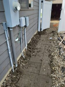 Exterior electrical meter and conduit installation on a house by Minards Electric LLC in Dickinson, ND.