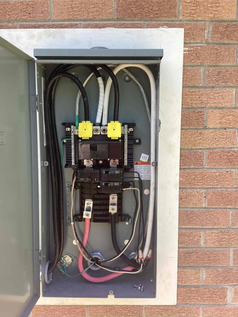 An open exterior electrical service panel showing wiring and components, serviced by Mister Sparky of Columbia in West Columbia, SC.