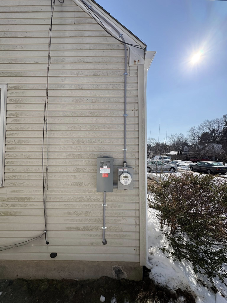 Exterior electrical meter and service conduit installed on a house by J Pownall Electric LLC in Hamilton, NJ.