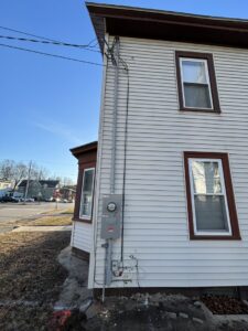 Exterior electrical service upgrade on a residential building by Kevin Kelley Electrical Inc in Leominster, MA.