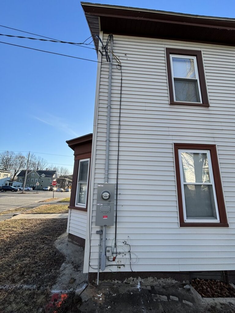 Exterior electrical service upgrade on a residential building by Kevin Kelley Electrical Inc in Leominster, MA.