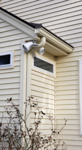An exterior floodlight installed under the eaves of a house by KC Electric in Pompton Plains, NJ.