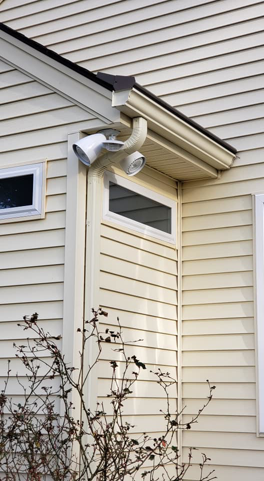 An exterior floodlight installed under the eaves of a house by KC Electric in Pompton Plains, NJ.