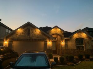 A residential house at dusk showcasing beautiful exterior accent lighting installed by LOJ Electric, LLC in Houston, TX.