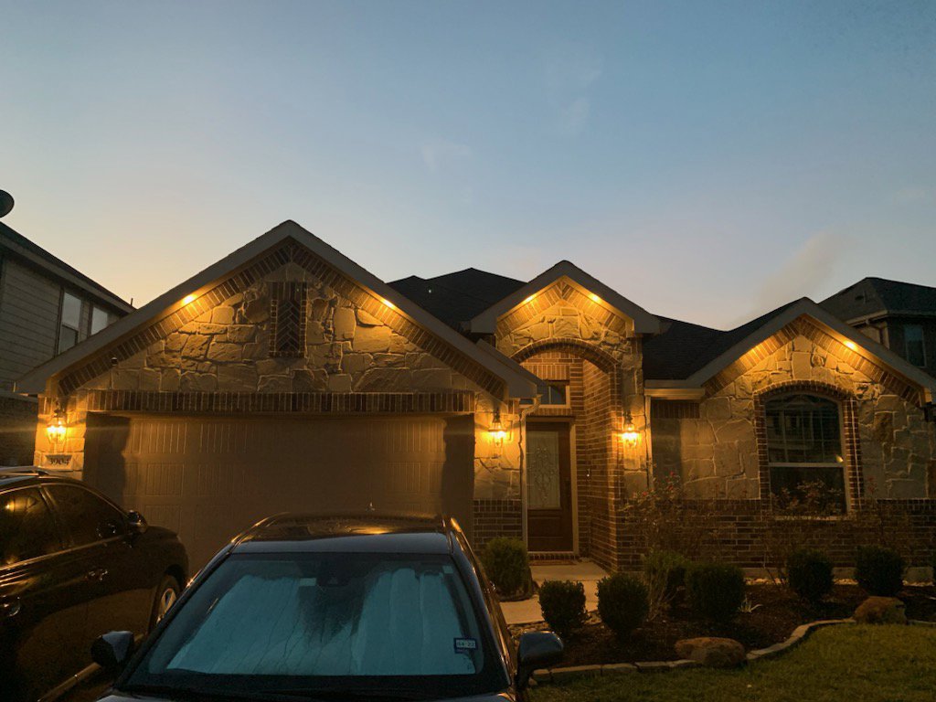 A residential house at dusk showcasing beautiful exterior accent lighting installed by LOJ Electric, LLC in Houston, TX.