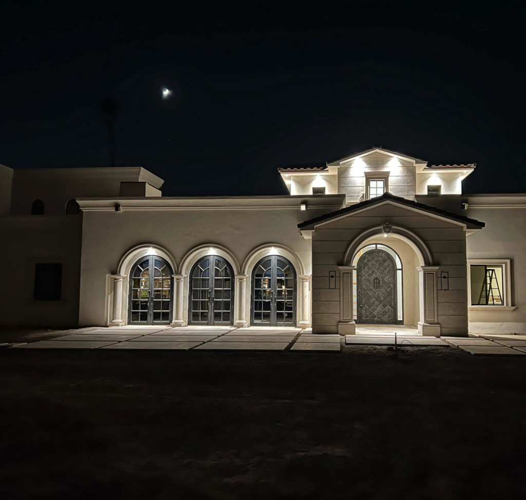 Beautiful exterior lighting illuminating a house at night, installed by Desert Sun Electrical in Mesa, AZ.