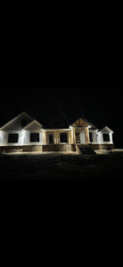 A newly built home illuminated by professional exterior and landscape lighting installed by JMD Electric, LLC in O'Fallon, MO.