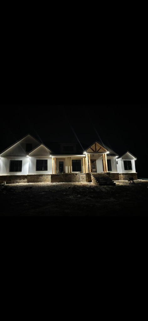 A newly built home illuminated by professional exterior and landscape lighting installed by JMD Electric, LLC in O'Fallon, MO.