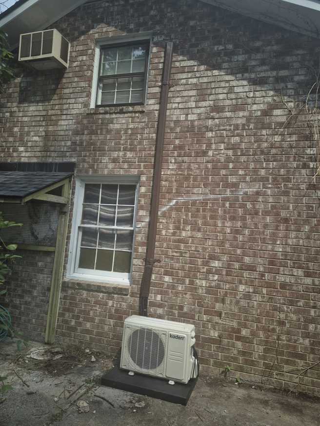 An outdoor Kaden mini-split condenser unit installed on a house exterior by Kirk Heating & Air Conditioning in Summerville, SC.