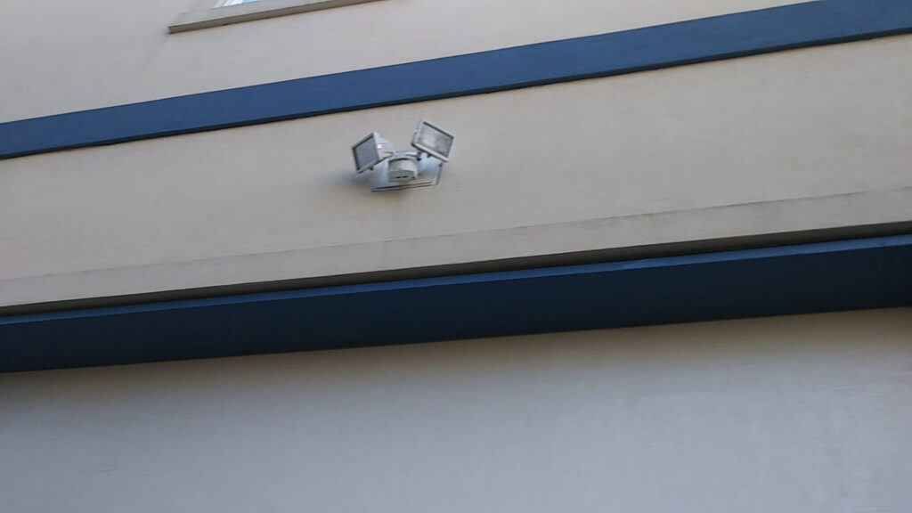 An exterior motion-sensor floodlight fixture installed by Elmore Electric, providing lighting solutions in Dover, IL.