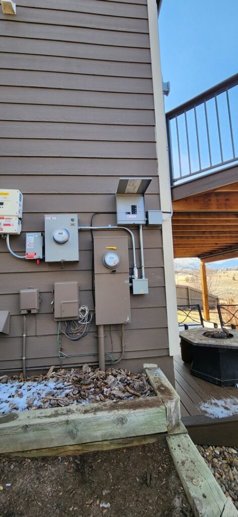 Exterior electrical panel with multiple meters and conduits installed by Midway Electric Inc. in Columbia, MO.