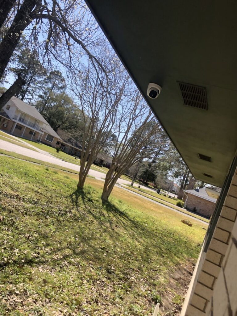 An exterior security camera mounted on a building's soffit, installed by Greater Baton Rouge Electric in Baton Rouge, LA.