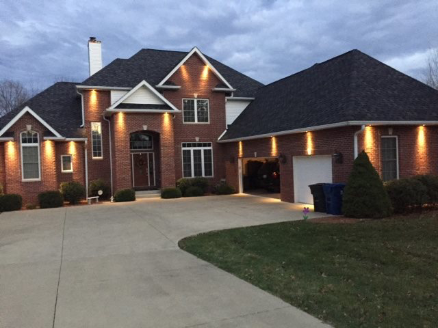Exterior soffit lighting installation on a brick home by Crandall Home Solutions, LLC in Bloomington, IN.