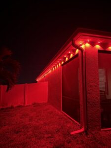 Exterior soffit lighting installation with red LED lights by Ryno Electric in Cape Coral, FL